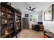 Functional home office with a dark bookcase, desk, and natural light, creating a productive workspace at 10714 E Lincoln Ave, Mesa, AZ 85212