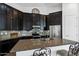 Gourmet kitchen with dark cabinetry, granite counters, and stainless steel appliances at 10714 E Lincoln Ave, Mesa, AZ 85212