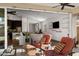 Inviting living space with modern decor flows from indoors to the covered patio with comfortable seating and open floor plan at 10714 E Lincoln Ave, Mesa, AZ 85212