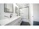 Beautiful bathroom features double sinks, white cabinets, sleek countertops, and a glass-enclosed shower and tub combination at 10910 N Thunderbird Rd, Maricopa, AZ 85139
