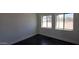 Bright bedroom with dual windows and dark flooring, creating a cozy atmosphere at 10910 N Thunderbird Rd, Maricopa, AZ 85139