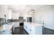 Charming kitchen boasts white cabinets, stainless steel appliances, sleek countertops, and a functional center island at 10910 N Thunderbird Rd, Maricopa, AZ 85139