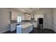 Bright kitchen with white cabinets, marble countertops, and stainless steel appliances at 10910 N Thunderbird Rd, Maricopa, AZ 85139