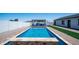 Sparkling blue swimming pool with stone accents and an outdoor kitchen with bar seating at 10910 N Thunderbird Rd, Maricopa, AZ 85139