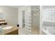 Bright bathroom features double sinks and a stand up shower with decorative glass block window at 11059 E Kilarea Ave, Mesa, AZ 85209