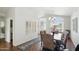 Bright dining room featuring a chandelier, large windows, and stylish decor at 11059 E Kilarea Ave, Mesa, AZ 85209