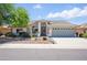 Charming single-story home features a desert landscape, covered entry, and a two-car garage at 11059 E Kilarea Ave, Mesa, AZ 85209
