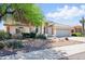 Well-maintained single-story home showcasing manicured landscaping, desert accents, and an attached garage at 11059 E Kilarea Ave, Mesa, AZ 85209