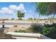 Inviting front porch area overlooking a serene neighborhood street and lush greenery at 11059 E Kilarea Ave, Mesa, AZ 85209