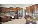Modern kitchen showcasing stainless steel appliances, wooden cabinets, and tile flooring at 11059 E Kilarea Ave, Mesa, AZ 85209