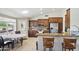 Well-lit kitchen featuring stainless appliances, a breakfast bar, and a casual dining area at 11059 E Kilarea Ave, Mesa, AZ 85209