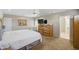 Spacious main bedroom with a ceiling fan, carpet flooring, and ensuite bathroom at 11059 E Kilarea Ave, Mesa, AZ 85209