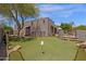 This backyard is a desert oasis, featuring a putting green, landscaped areas, and a harmonious blend of natural beauty at 11123 E Monument Dr, Scottsdale, AZ 85262