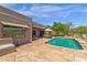 This house offers a backyard oasis with a pool, outdoor kitchen, and cozy seating, all set in a tranquil desert landscape at 11123 E Monument Dr, Scottsdale, AZ 85262
