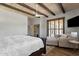 Bedroom features wood floors, a ceiling with exposed wood beams, and a television at 11123 E Monument Dr, Scottsdale, AZ 85262