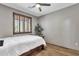 Bedroom shows a white bedspread with a ceiling fan and window with wooden shutters at 11123 E Monument Dr, Scottsdale, AZ 85262