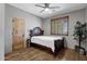 Bedroom features hardwood floors, a ceiling fan, and a window with wooden shutters at 11123 E Monument Dr, Scottsdale, AZ 85262