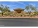Elegant clubhouse entrance featuring a waterfall and professionally maintained desert landscaping at 11123 E Monument Dr, Scottsdale, AZ 85262
