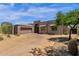 Stunning exterior view of a contemporary home with a spacious driveway and desert-friendly landscaping at 11123 E Monument Dr, Scottsdale, AZ 85262