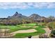 Beautiful golf course view featuring lush greens, sand traps and mountain scenery in the background at 11123 E Monument Dr, Scottsdale, AZ 85262