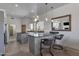 Stylish kitchen featuring white cabinets, granite countertops, a center island, and stainless steel appliances at 11123 E Monument Dr, Scottsdale, AZ 85262