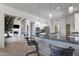 Open-concept kitchen with a breakfast bar that opens to the living room with fireplace at 11123 E Monument Dr, Scottsdale, AZ 85262