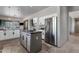 Well-equipped kitchen with stainless steel appliances, a central island, and white cabinetry at 11123 E Monument Dr, Scottsdale, AZ 85262