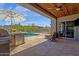 This home's outdoor patio offers a private pool, ceiling fan, and an outdoor kitchen, all perfect for relaxing or entertaining guests at 11123 E Monument Dr, Scottsdale, AZ 85262