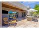 This outdoor patio has beautiful flagstone flooring, a full outdoor kitchen, and comfortable seating with an outdoor television at 11123 E Monument Dr, Scottsdale, AZ 85262