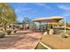 Community playground and picnic area shaded by a ramada with desert landscaping at 11123 E Monument Dr, Scottsdale, AZ 85262