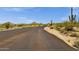 Desert mountain community street lined with native vegetation and distant views at 11123 E Monument Dr, Scottsdale, AZ 85262