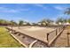 Community tennis court with a perimeter landscape design and beautiful desert trees at 11123 E Monument Dr, Scottsdale, AZ 85262