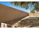 This backyard has desert landscaping, a block wall, and a shady tree at 12443 W Via Camille --, El Mirage, AZ 85335