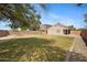Spacious backyard features lawn, gravel borders, and a tall block perimeter wall at 12443 W Via Camille --, El Mirage, AZ 85335