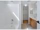 This bathroom features a shower over tub, tile floor, and access to a closet with shelving at 12443 W Via Camille --, El Mirage, AZ 85335