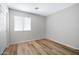 Bedroom with luxury vinyl plank flooring, a window with blinds, and a closet at 12443 W Via Camille --, El Mirage, AZ 85335