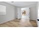 Bedroom with wood-look flooring, one window, and a door leading to a backyard patio at 12443 W Via Camille --, El Mirage, AZ 85335