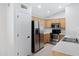 Well-lit kitchen features stainless steel appliances, light oak cabinetry and a neutral tile floor at 12443 W Via Camille --, El Mirage, AZ 85335
