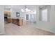 Open kitchen with a breakfast bar, stainless steel appliances, and warm-toned cabinets at 12443 W Via Camille --, El Mirage, AZ 85335