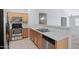 Bright kitchen offers stainless steel appliances, light cabinetry, and tiled flooring at 12443 W Via Camille --, El Mirage, AZ 85335