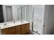 Bright bathroom featuring a double sink vanity and glass-enclosed shower at 12505 W Adams St, Avondale, AZ 85323