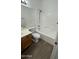 Bright bathroom featuring a shower-tub combination, light wood cabinets, and wood-look flooring at 12505 W Adams St, Avondale, AZ 85323