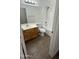 Bathroom with a white shower-tub combination, light wood cabinets, and wood-look flooring at 12505 W Adams St, Avondale, AZ 85323