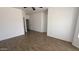 Spacious bedroom with wood-look tile flooring and neutral walls and ceiling at 12505 W Adams St, Avondale, AZ 85323
