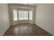 Bedroom with natural light from a window, neutral finishes, and wood-look tile flooring at 12505 W Adams St, Avondale, AZ 85323