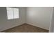 Bedroom filled with natural light from a window, featuring wood-look tile flooring at 12505 W Adams St, Avondale, AZ 85323