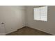 Bedroom featuring a window, closet, and neutral finishes, with wood-look tile flooring at 12505 W Adams St, Avondale, AZ 85323