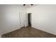 Bedroom featuring a closet, neutral finishes, and wood-look tile flooring at 12505 W Adams St, Avondale, AZ 85323