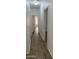 Hallway featuring neutral paint, wood-look tile, and doorways to other rooms at 12505 W Adams St, Avondale, AZ 85323