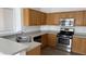 Kitchen featuring wood cabinets, gray countertops and stainless steel appliances at 12505 W Adams St, Avondale, AZ 85323